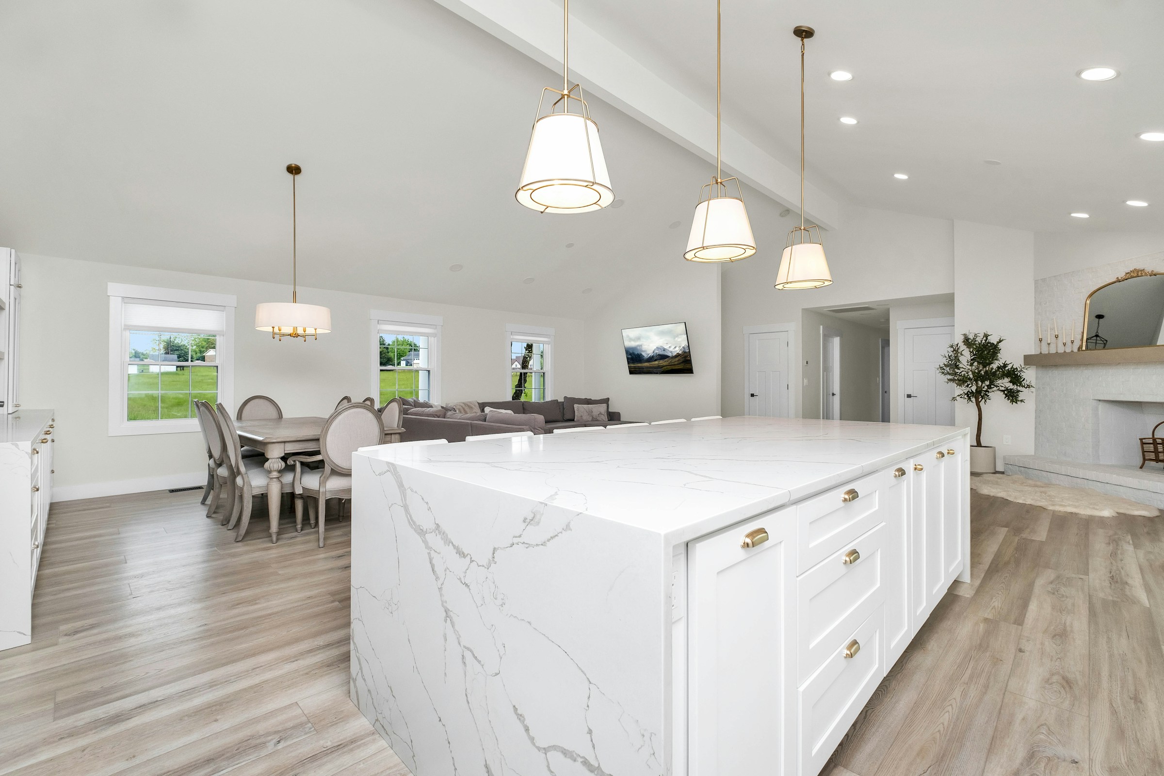 Large white kitchen with a marble island