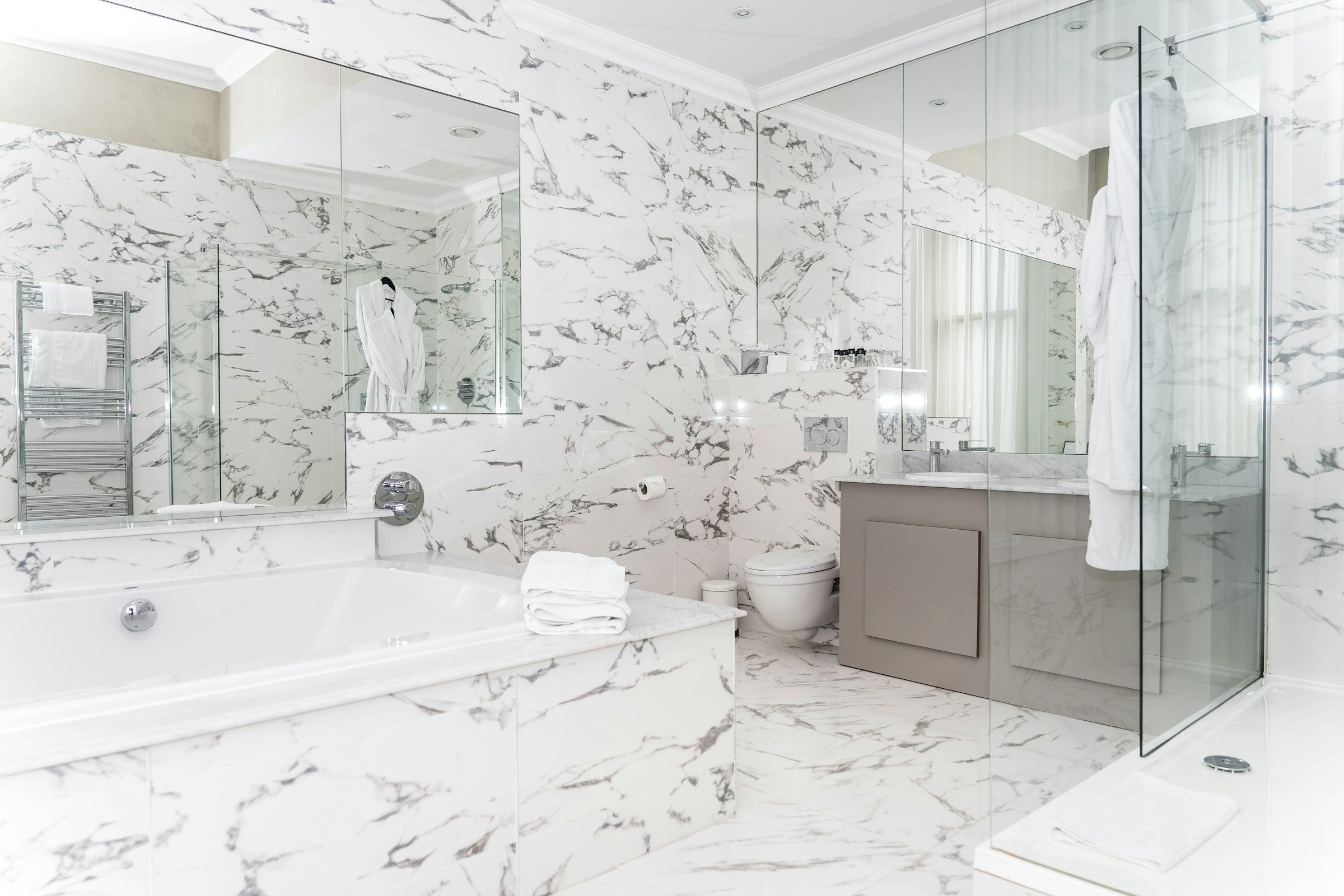 Luxury marble bathroom with stone walls and bath surround